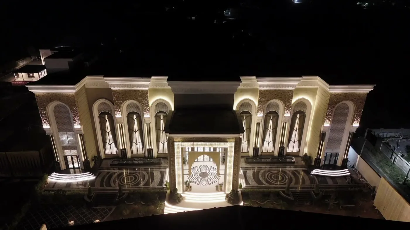 The illuminated palace facade and entrance steps